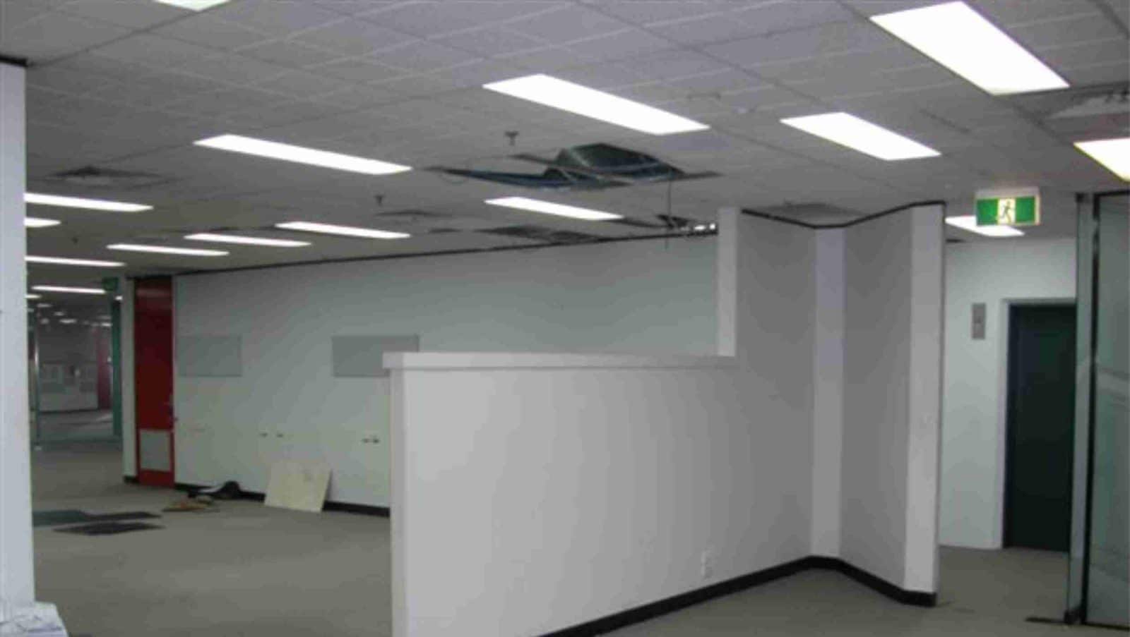 An office tenancy with ceiling tiles removed during an end of lease strip out
