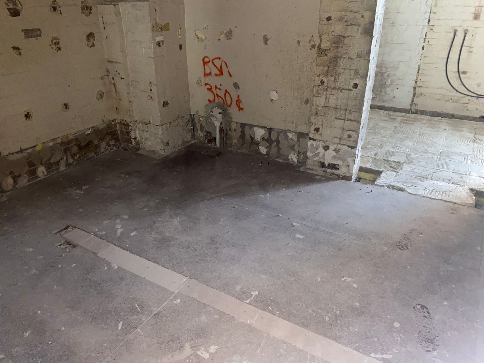 An empty retail tenancy stripped back to bare walls and a concrete floor