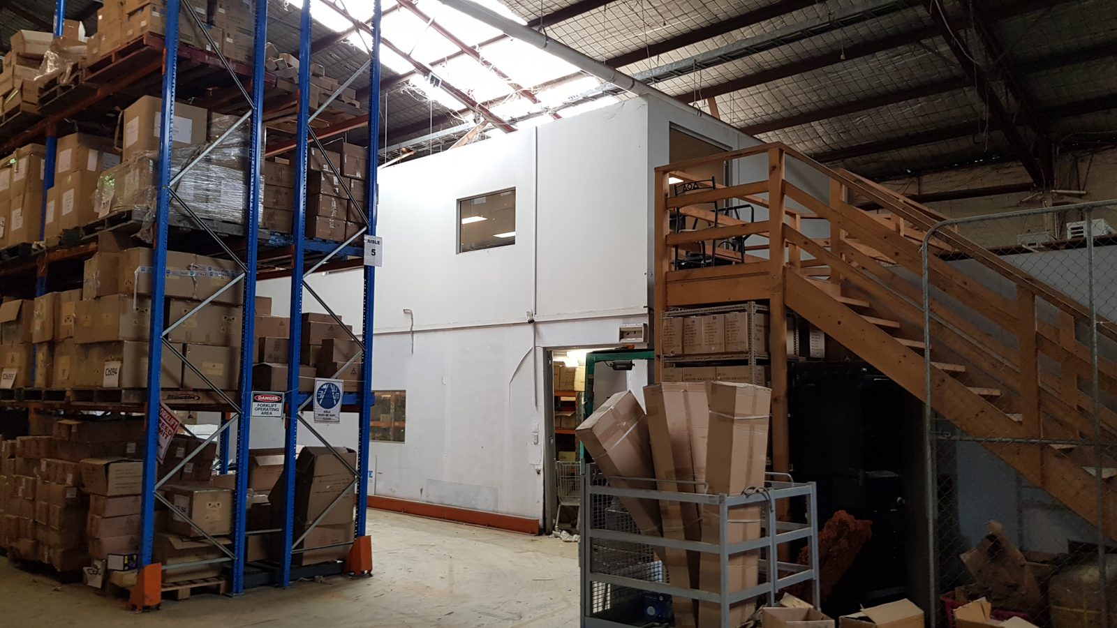 An internal office and mezzanine built inside a warehouse tenancy